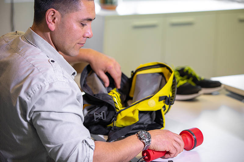 A man packing his grab bag